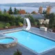 Picture of a new inground pool project with a water slide.