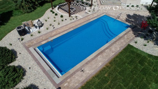 Swimming pool with pergola on the side.
