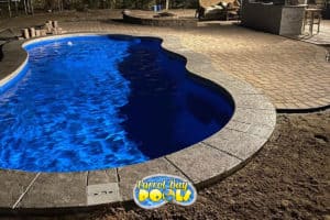inground fiberglass pool with paver patio