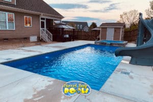 inground fiberglass pool with spillover spa and twist slide