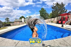 girl does a wet hair flip in her new inground fiberglass pool