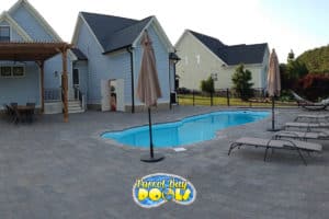 inground fiberglass pool with paver decking