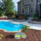 inground fiberglass pool with beautiful landscaping