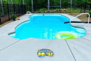 inground fiberglass pool with concrete patio