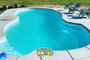 inground fiberglass pool with concrete patio and deck chairs