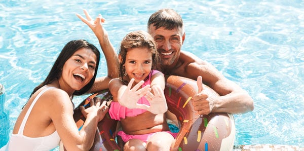 Family smiling in pool