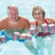 Picture of a couple in their inground pool trying new pool exercises.