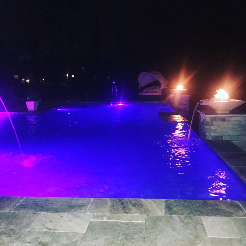 Photo of pool lights at night.